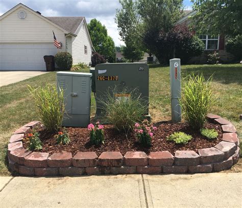 how to hide electrical boxes in yard|decorative fencing to hide utilities.